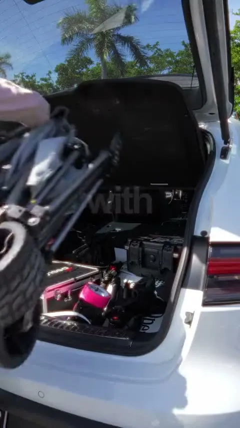 A film crew unloading gear from an SUV for a real estate shoot
